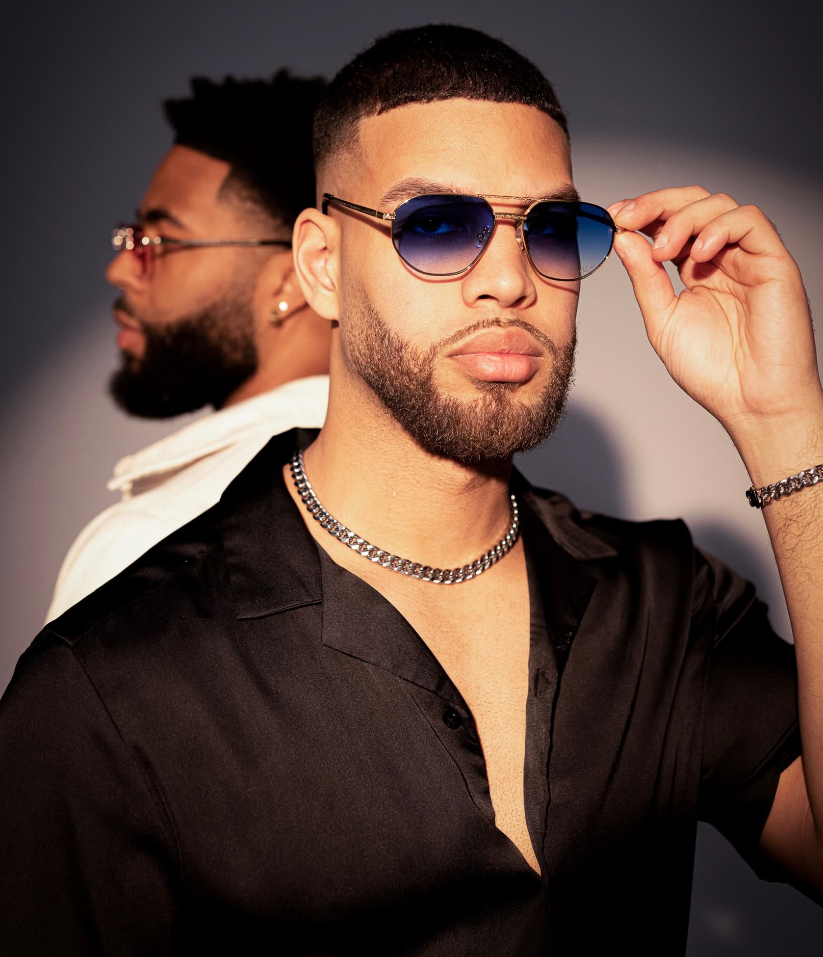 Editorial portrait of DeLuxe eyewear worn on-figure.