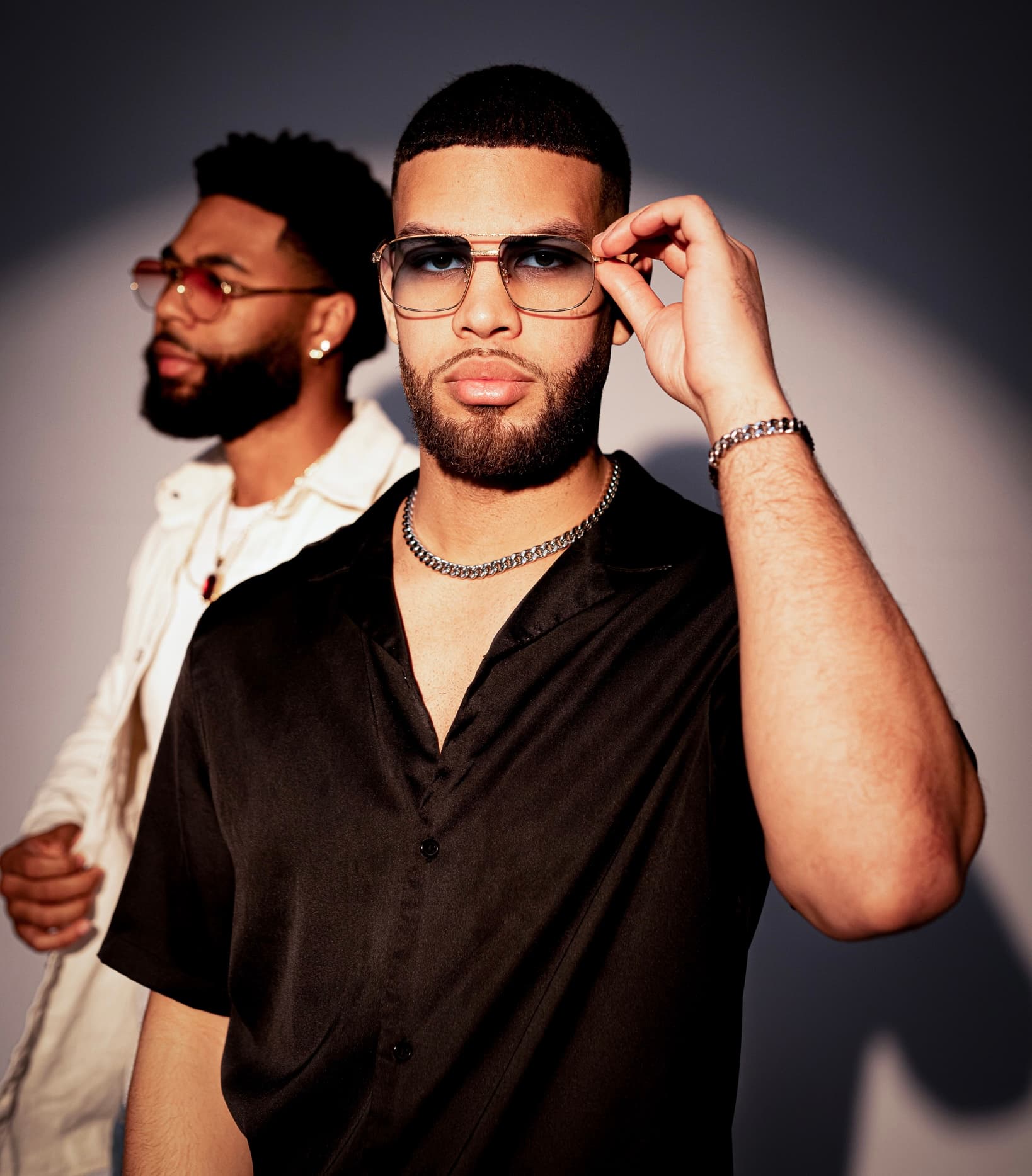 Editorial portrait of DeLuxe eyewear worn on-figure.